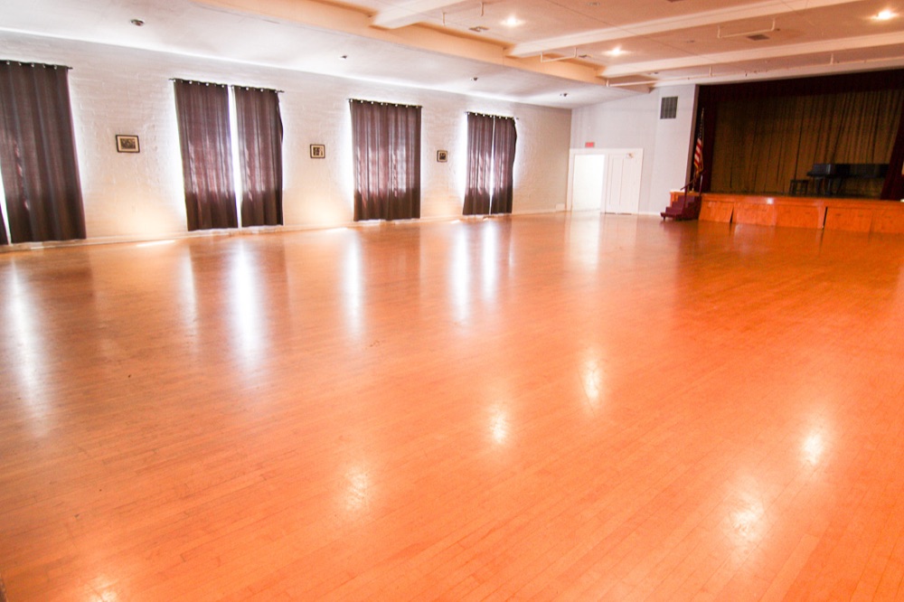 The Grand Ballroom / historic Auditorium with hardwood floors and stage